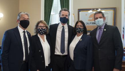 Asm. Aguiar-Curry poses with Gov. Newsom and other California leaders