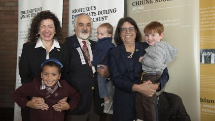 Asm. Aguiar-Curry takes a picture with an honoree and his family at the 2018 Legislative Jewish Caucus' Holocaust Remembrance Brunch
