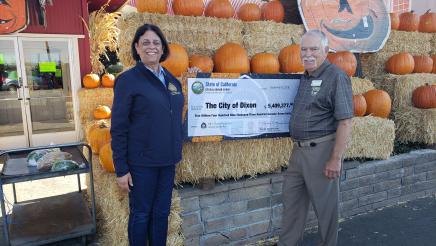 Assemblymember Aguiar-Curry presents check for $5,409,377 to Dixon Vice Mayor Ted Hickman