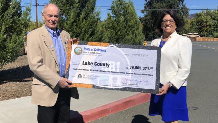 Assemblymember Aguiar-Curry presents check for $39,665,371 to Board Chair Supervisor Jim Steele of Lake County