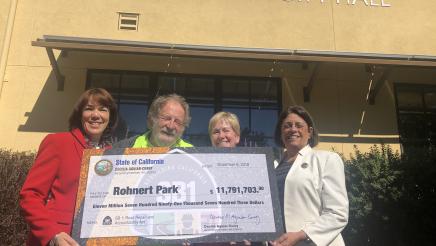 Assemblymember Aguiar-Curry presents check for $11,791,703 to Rohnert Park City Council - Gina Belforte, Jack Mackenzie, and Mayor Pam Stafford