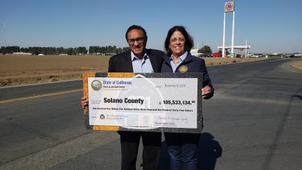 Assemblymember Aguiar-Curry presents check for $105,533,134 to Supervisor John Vasquez of Solano County